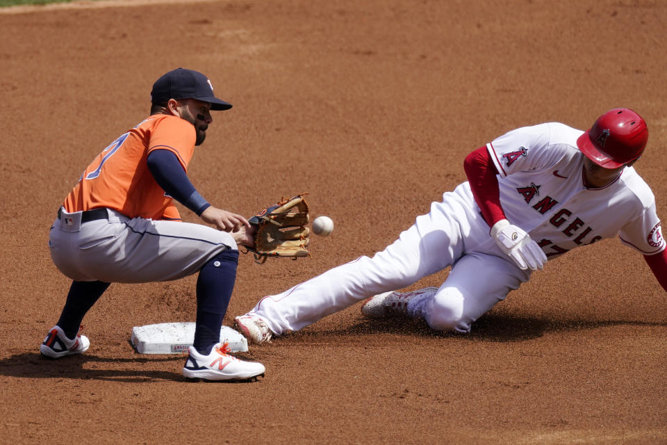 Los Angeles Angels' Shohei Ohtani, right, steals second as Houston Astros second baseman Jose Altuve takes a late throw during the first inning of a baseball game Tuesday, April 6, 2021, in Anaheim, Calif. (AP Photo/Mark J. Terrill)