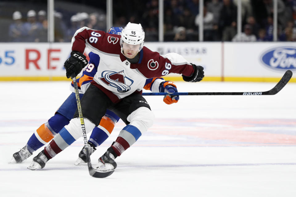 Colorado Avalanche right wing Mikko Rantanen (96) keeps the puck from New York Islanders center Brock Nelson (29) during the second period of an NHL hockey game, Monday, Jan. 6, 2020, in Uniondale, N.Y. (AP Photo/Kathy Willens)