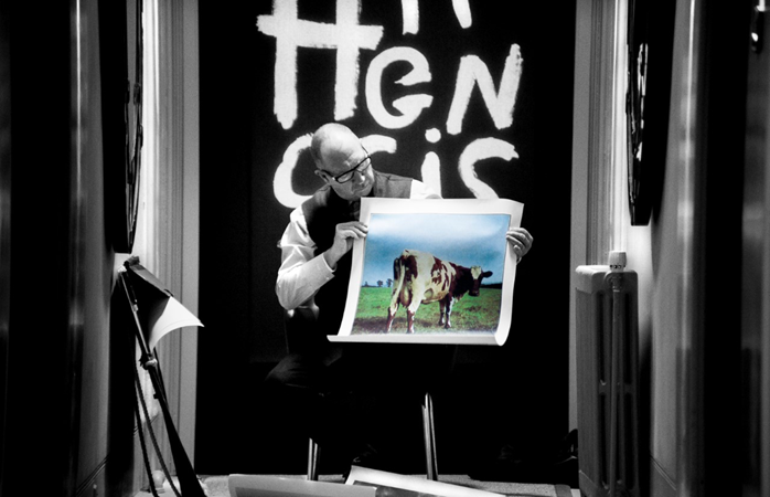 Aubrey “Po” Powell with holds an album cover image designed by Hipgnosis - Credit: Anton Corbijn