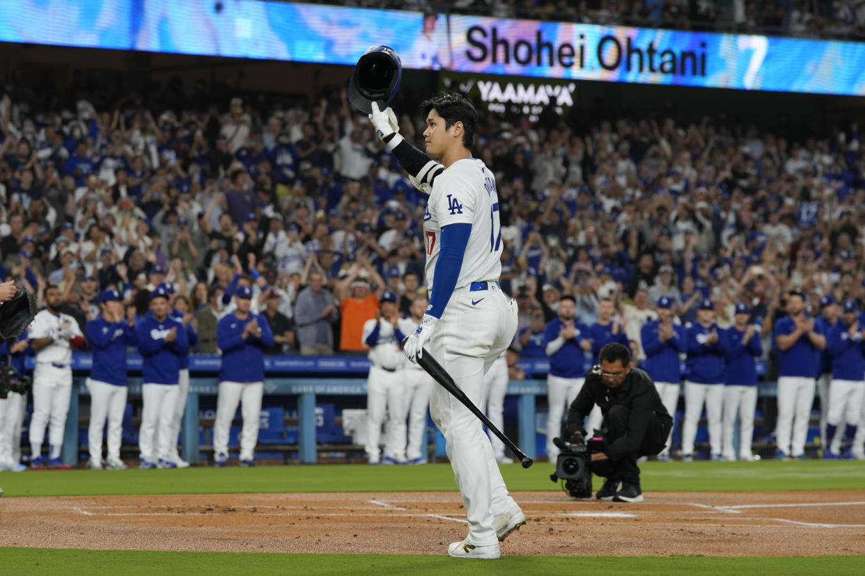 Los Angeles Dodgers designated hitter Shohei Ohtani (17) is honored during the first inning of a baseball game against the Colorado Rockies in Los Angeles, Friday, Sept. 20, 2024. Ohtani was the first MLB player to achieve 50 home runs and 50 stolen bases in a single season. (AP Photo/Ashley Landis)