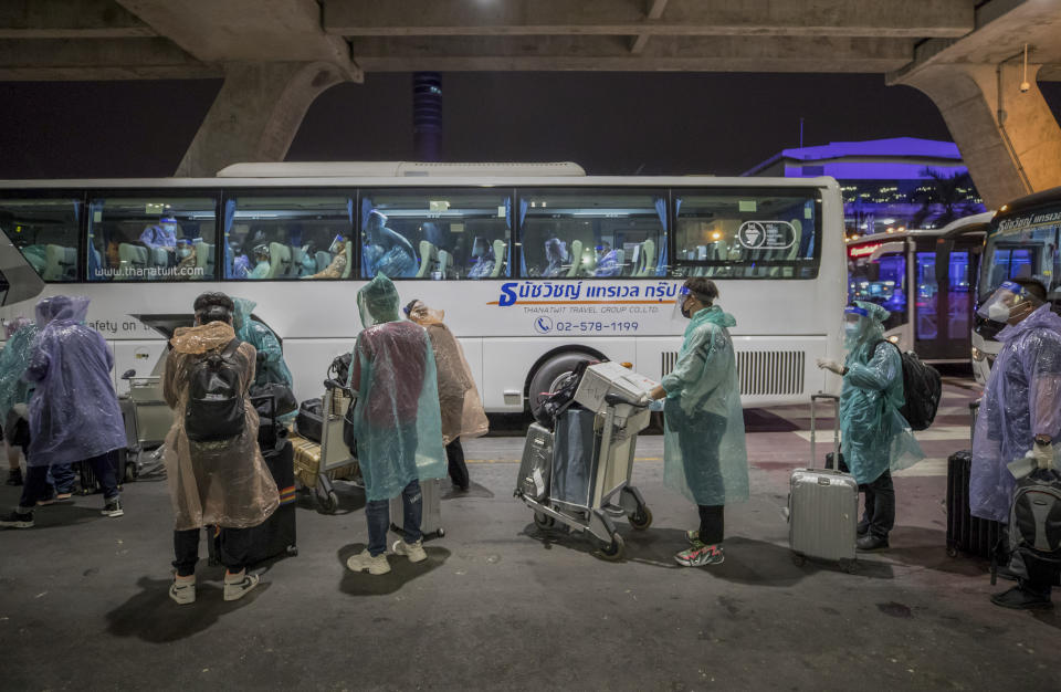 Chinese tourists from Shanghai who arrived on special tourist visas, board a bus at Suvarnabhumi airport in Bangkok, Thailand, Tuesday, Oct. 20, 2020. Thailand on Tuesday took a modest step toward reviving its coronavirus-battered tourist industry by welcoming 39 visitors who flew in from Shanghai, the first such arrival since normal traveler arrivals were banned almost seven months ago. (AP Photo/Wason Wanichakorn)