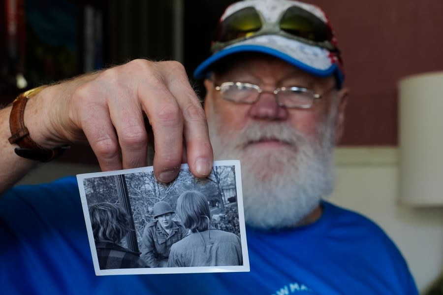 <em>Dean Kahler, who was shot an paralyzed at Kent State University on May 4, 1970, holds a photograph he took of a U.S. National Guardsman talking to students during the 1970 anti-war protest, during an interview in his home Thursday, May 2, 2024, in Plain Township, Ohio. (AP Photo/Sue Ogrocki)</em>
