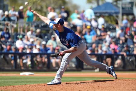 FILE PHOTO: Mar 7, 2019; Port Charlotte, FL, USA; Toronto Blue Jays pitcher John Axford (77) throws a pitch during the fourth inning against the Tampa Bay Rays at Charlotte Sports Park. Mandatory Credit: Kim Klement-USA TODAY Sports