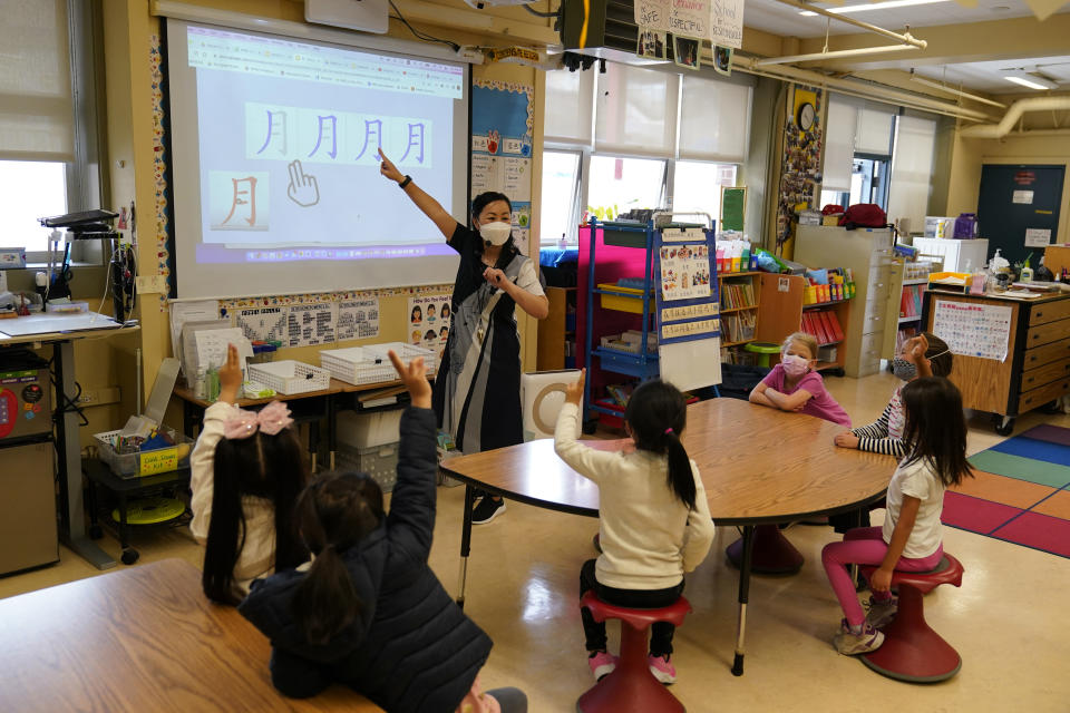 First grade teacher Suzy Tom leads a class at the Alice Fong Yu school in San Francisco, Tuesday, Aug. 30, 2022. The school is the nation's first Chinese immersion public school and provides Cantonese instruction from kindergarten until the 8th grade. While Cantonese may be on a downward trajectory, it's not dying. Online campaigns, independent Chinese schools and Cantonese communities in and outside of Chinatowns are working to ensure future generations can carry it forward. (AP Photo/Eric Risberg)