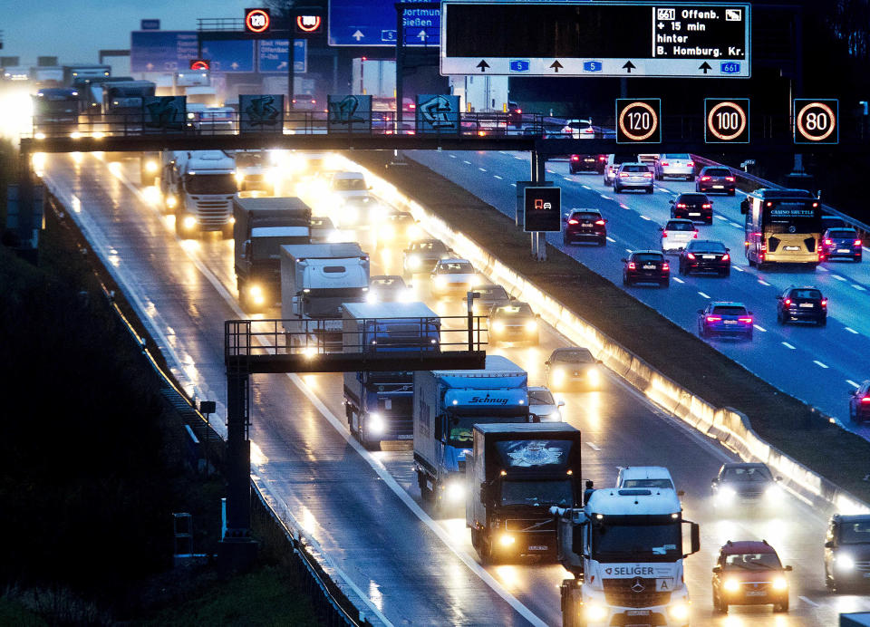 Trucks are lined up as hey roll down a highway in Frankfurt, Germany, Monday, Dec. 3, 2018. The COP24 UN Climate Change Conference is taking place in Katowice, Poland. Negotiators from around the world are meeting for talks on curbing climate change. (AP Photo/Michael Probst)