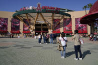 Fans stand outside Angel Stadium when a baseball game between the Minnesota Twins and the Los Angeles Angels was postponed Saturday, April 17, 2021, in Anaheim, Calif. MLB said the game was postponed to allow for continued COVID-19 testing and contact tracing involving members of the Twins organization. (AP Photo/Ashley Landis)