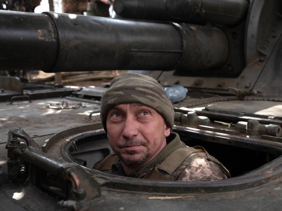 A Ukrainian soldier looks skyward as he prepares to fire on Russian positions at the frontline, near Bakhmut, on March 25.  (Efrem Lukatsky/The Associated Press - image credit)