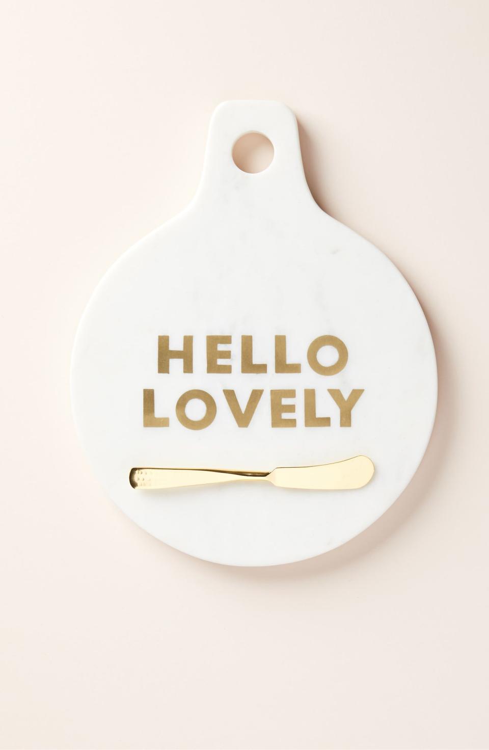 White marble cheese plate with gold writing that says 'hello lovely'