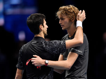 Tennis - ATP Finals - The O2, London, Britain - November 18, 2018 Germany's Alexander Zverev hugs Serbia's Novak Djokovic as he celebrates winning the final Action Images via Reuters/Tony O'Brien