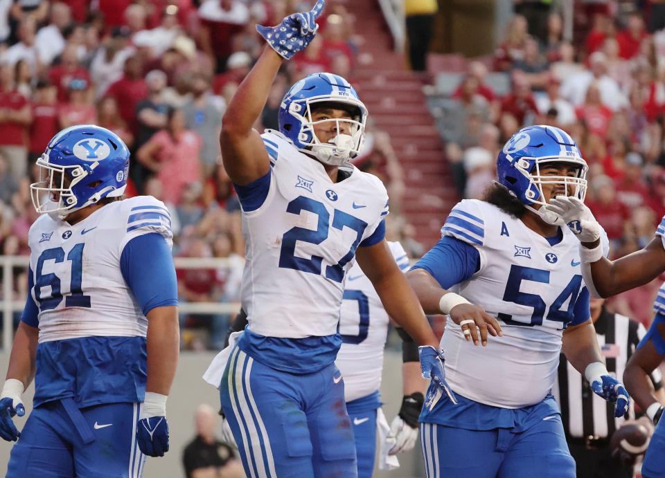 Brigham Young Cougars running back LJ Martin (27) celebrates his touchdown against the Arkansas Razorbacks at Razorback Stadium.