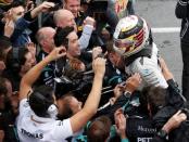 Formula One - Canadian Grand Prix - Montreal, Quebec, Canada - 12/6/16 - Mercedes driver Lewis Hamilton celebrates winning the race. REUTERS/Chris Wattie