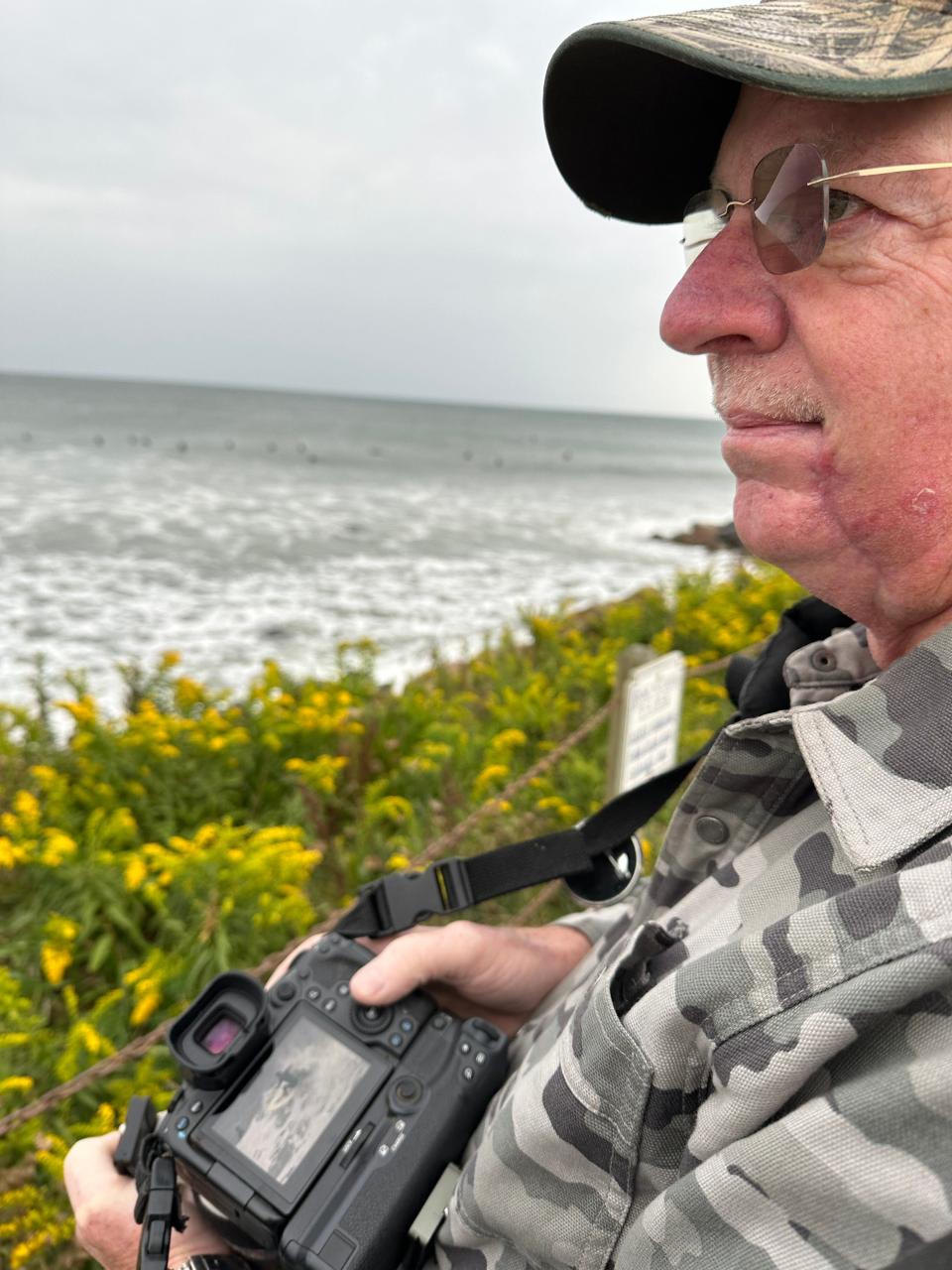 Normally a bird photographer, Peter Ryan of East Greenwich was out Saturday morning at Pt. Judith to take photos of surfers riding Hurricane Lee's waves.