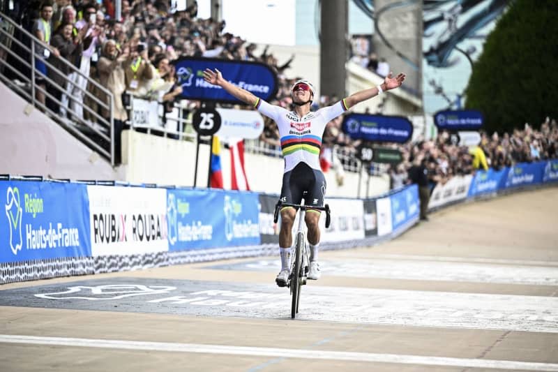 Dutch cyclist Mathieu Van Der Poel of the UCI WorldTeam Alpecin–Deceuninck celebrates as he crosses the finish line to win the 121st edition of the Paris-Roubaix one-day classic cycling race, 260km between Compiegne and Roubaix. Jasper Jacobs/Belga/dpa