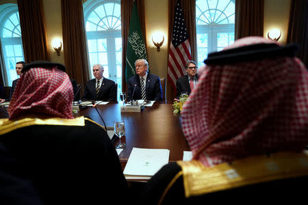 U.S. President Donald Trump, flanked by ‪Vice President Mike Pence‬ (L) and Energy Secretary Rick Perry (R), hosts Saudi Arabia's Crown Prince Mohammed bin Salman for a working lunch at the White House in Washington, U.S. March 20, 2018. REUTERS/Jonathan Ernst