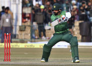 Pakistan batsman Mohammad Hafeez follows the ball after playing a shot during the second T20 cricket match against Bangladesh at Gaddafi stadium, in Lahore, Pakistan, Saturday, Jan. 25, 2020. (AP Photo/K.M. Chaudary)