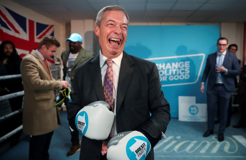 Brexit Party leader Nigel Farage wears boxing gloves during a visit at a boxing gym in Ilford