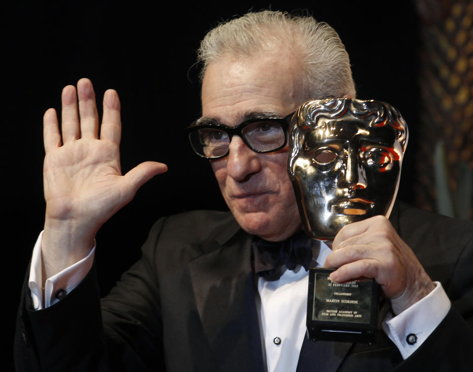 Director Martin Scorsese celebrates with his fellowship award at the British Academy of Film and Arts (BAFTA) awards ceremony at the Royal Opera House in London February 12, 2012. REUTERS/Suzanne Plunkett (BRITAIN - Tags: ENTERTAINMENT) (BAFTA-WINNERS)