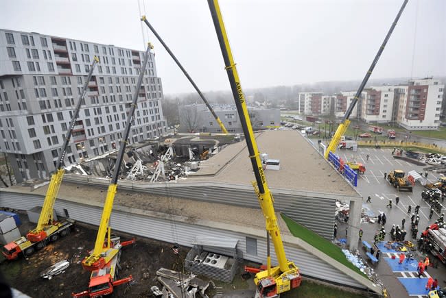 A view of the collapsed Maxima supermarket in Riga, Latvia, Friday, Nov. 22, 2013. At least 32 people died, including three firefighters, after an enormous section of roof collapsed at a Latvian supermarket in the country's capital, emergency medical officials said Friday. The reason for the collapse during shopping rush-hour Thursday was still not known but rescue and police officials said that possible theories include building's design flaws and poor construction work. (AP Photo/ Roman Koksarov)