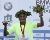 Winner Kenenisa Bekele of Ethiopia celebrates during the victory ceremony at the Berlin marathon in Berlin, Germany, September 25, 2016. REUTERS/Fabrizio Bensch