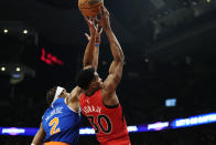 New York Knicks guard Miles McBride (2) fouls Toronto Raptors guard Ochai Agbaji (30) during the first half of an NBA basketball game Wednesday, March 27, 2024, in Toronto. (Frank Gunn/The Canadian Press via AP)