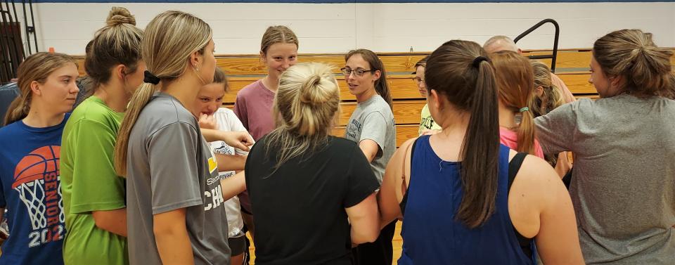 Poland softball coach Erin Meeker (center) gives final instructions to the Tornadoes as Tuesday's practice breaks up in the Linda Trzepacz Memorial Gymnasium. The workout was the team's last before departing for New York's Class D Final Four on Long Island.