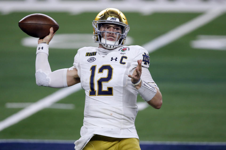 FILE - In this Jan. 1, 2021, file photo, Notre Dame quarterback Ian Book (12) throws a pass in the first half of the Rose Bowl NCAA college football game against Alabama in Arlington, Texas. Perhaps the best-known collegian selected in the fourth round Saturday was Book. And Book went somewhere with a QB opening: New Orleans, which saw career passing leader Drew Brees retire. (AP Photo/Roger Steinman, File)