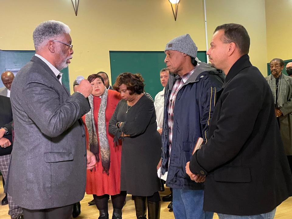 Lynn Coleman, left, addresses David Smith, the father of six children who died in a Jan. 21 house fire on South Bend's west side, as Smith's spiritual adviser, Elijah Luciano, stands to his left.