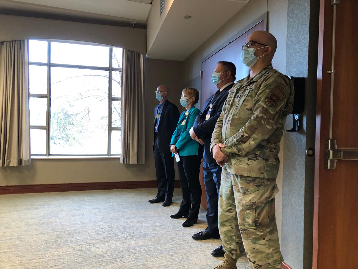 From right, Lt. Col. Joseph Huseman II, CentraCare President and CEO Kenneth Holmen, CentraCare Vice President of Population Health Kathy Parsons and CentraCare Vice President of Performance Excellence and Incident Commander for COVID-19 Response George Morris listen as Maj. Gen. Jeffrey Van speaks at a press conference at St. Cloud Hospital Monday, Nov. 29, 2021.