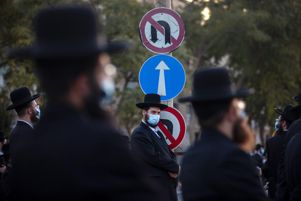 Ultra-Orthodox Jews wear face masks and keep social distancing amid concerns over the country's coronavirus outbreak, during a protest to what they say is incitement against the city and country's religious population in the southern Israel city of Arad, Israel, Monday, Oct. 19, 2020. (AP Photo/Oded Balilty)
