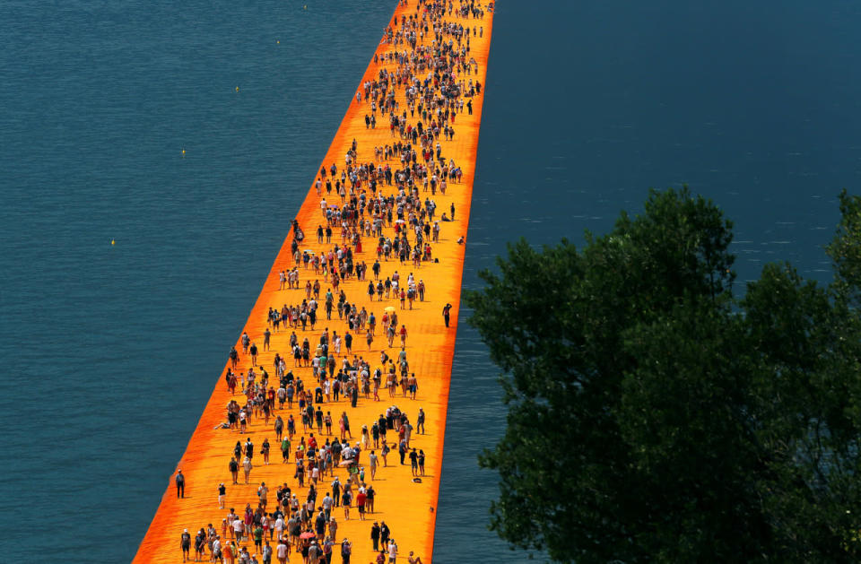 People walk on water at Italian lake 'Floating Piers’ installation