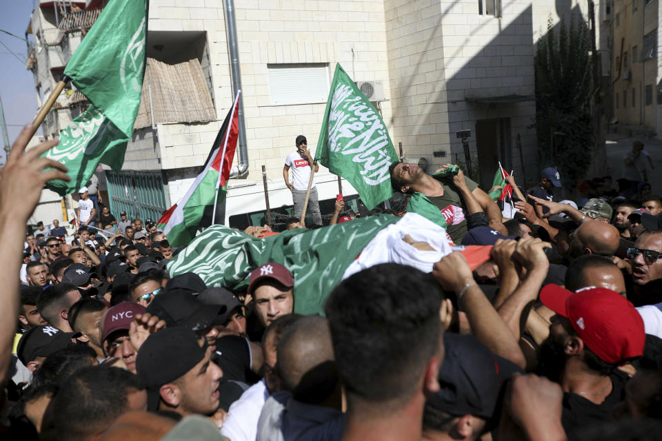 Mourners carry the body of Mohammed Obeid, a 20 year-old Palestinian killed in a clash with Israeli police on June 27, during his funeral in east Jerusalem, Monday, July 1, 2019. (AP Photo/Mahmoud Ilean)