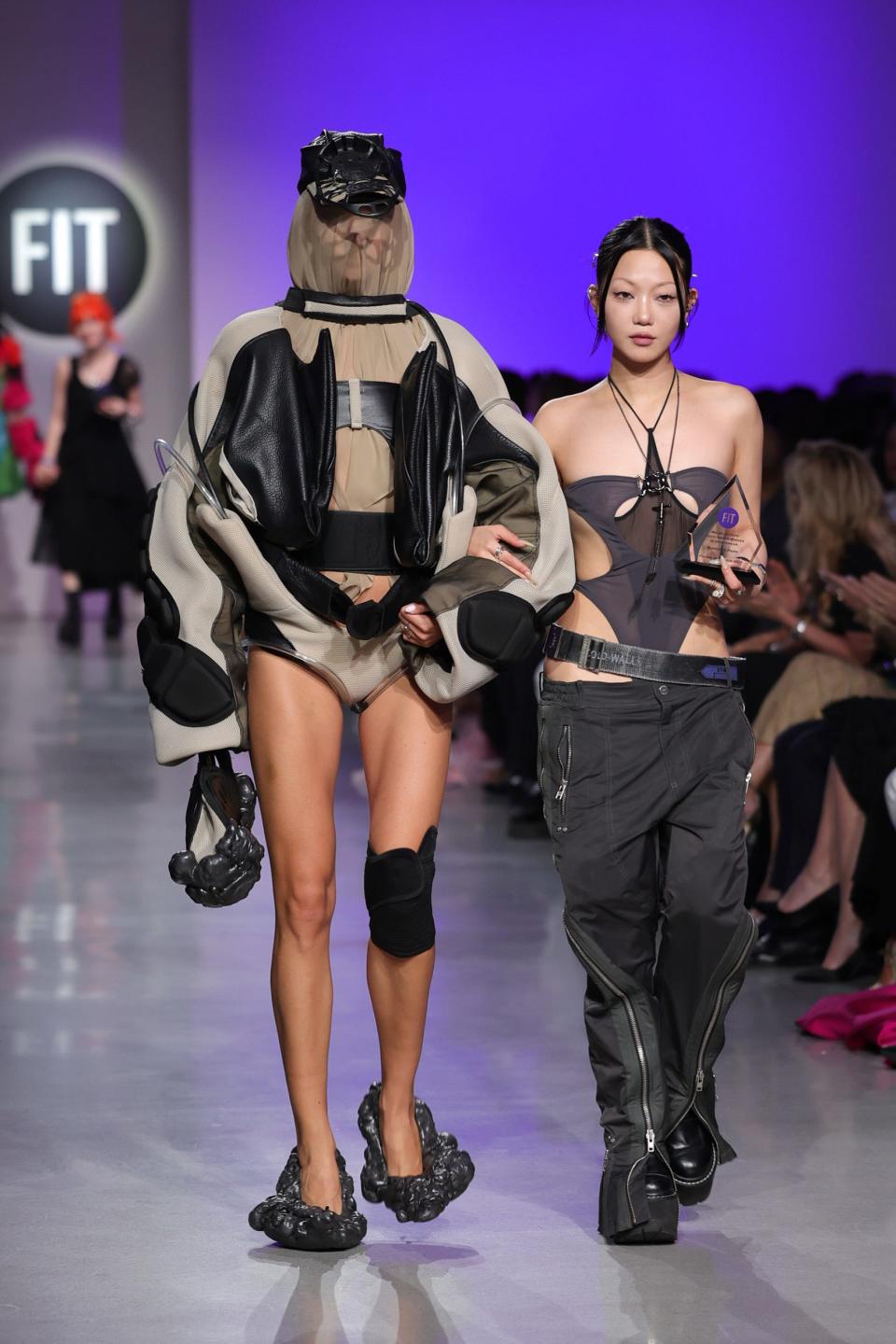 Critic Award Winner Sung Hye Park (R) walks the runway with her model during the the FIT Annual Awards Gala and the FIT Future of Fashion Runway Show.