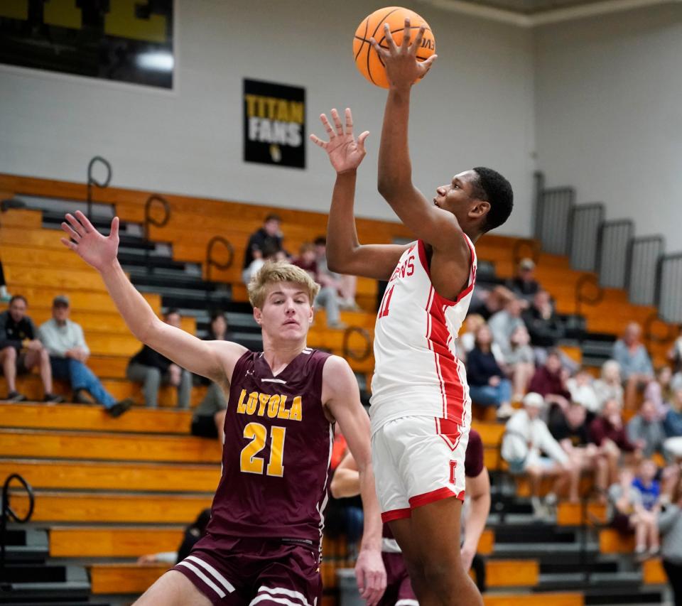 Immokalee Indians guard Marvin Museau (11) shoots the ball during the second half of a game against the Loyola Academy Ramblers at Golden Gate High School in Naples on Tuesday, Dec. 27, 2022. 