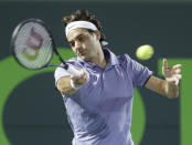 Roger Federer of Switzerland, returns a shot from Kei Nishikori of Japan, at the Sony Open Tennis tournament, Wednesday, March 26, 2014 in Key Biscayne, Fla. (AP Photo/Wilfredo Lee)