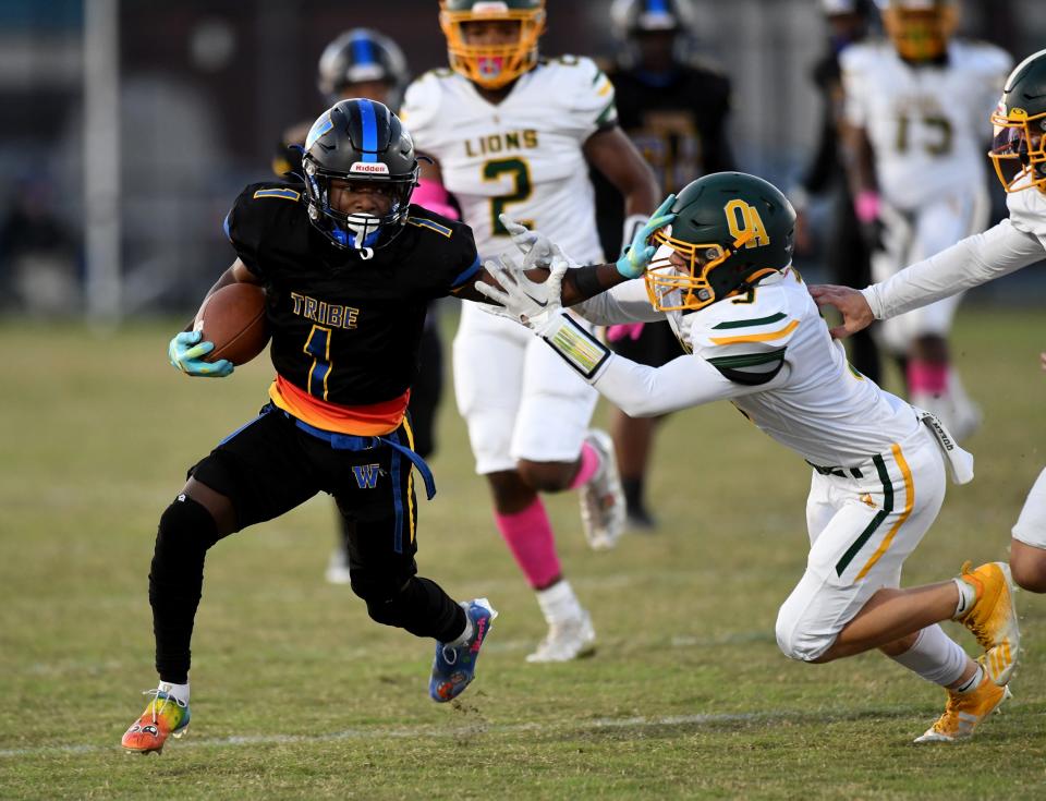 Wi-Hi's Malique Leatherbury (1) runs by Queen Anne's Thursday, Oct. 20, 2022, at Wicomico County Stadium in Salisbury, Maryland.