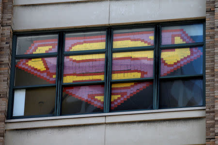 An image of the Superman Logo created with Post-it notes is seen in windows at 200 Hudson street in lower Manhattan, New York, U.S., May 18, 2016, where advertising agencies and other companies have started what is being called a "Post-it note art war" with employees in buildings across Canal street from each other creating colorful images in their windows with Post-it notes. REUTERS/Mike Segar