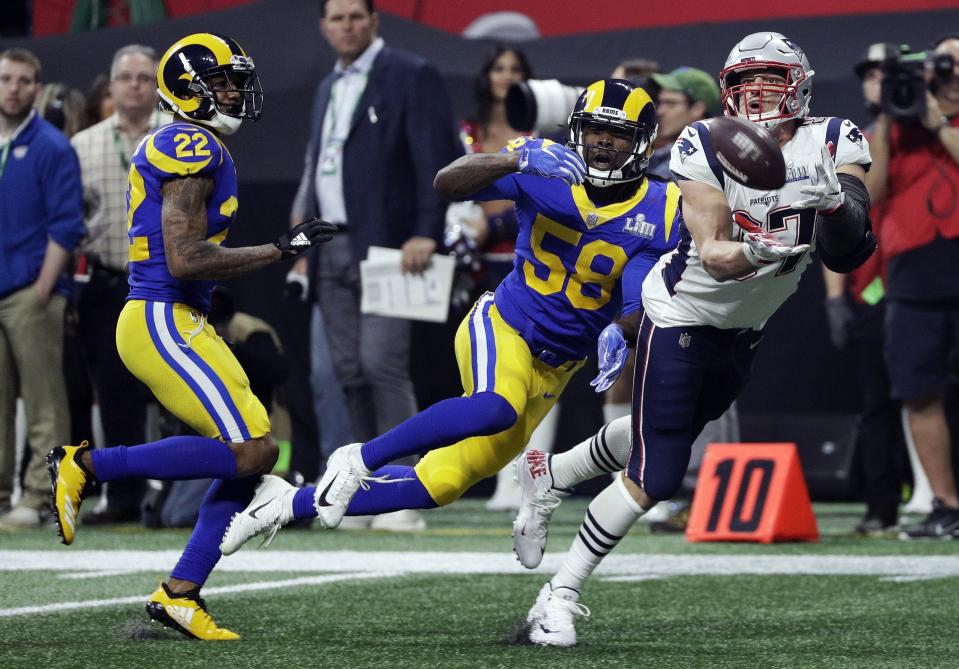 The Patriots’ Rob Gronkowski (87) catches a pass in front of the Rams’ Marcus Peters (22) and Cory Littleton (58) during the second half. (AP)