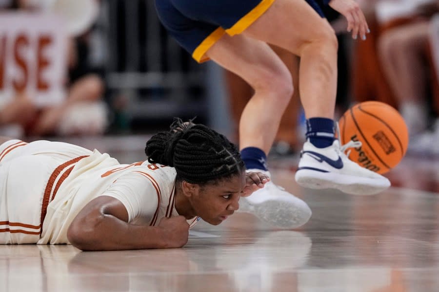 Texas forward Madison Booker, left, and Drexel guard Grace O’Neill, right, chase a loose ball during the first half of a first-round college basketball game in the women’s NCAA Tournament in Austin, Texas, Friday, March 22, 2024. (AP Photo/Eric Gay)