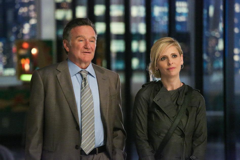 This publicity image released by CBS shows Robin Williams, left, and Sarah Michelle Gellar in a scene from the pilot episode of "The Crazy Ones," a new CBS comedy premiering in the fall of 2013. (AP Photo/CBS, Richard Cartwright)