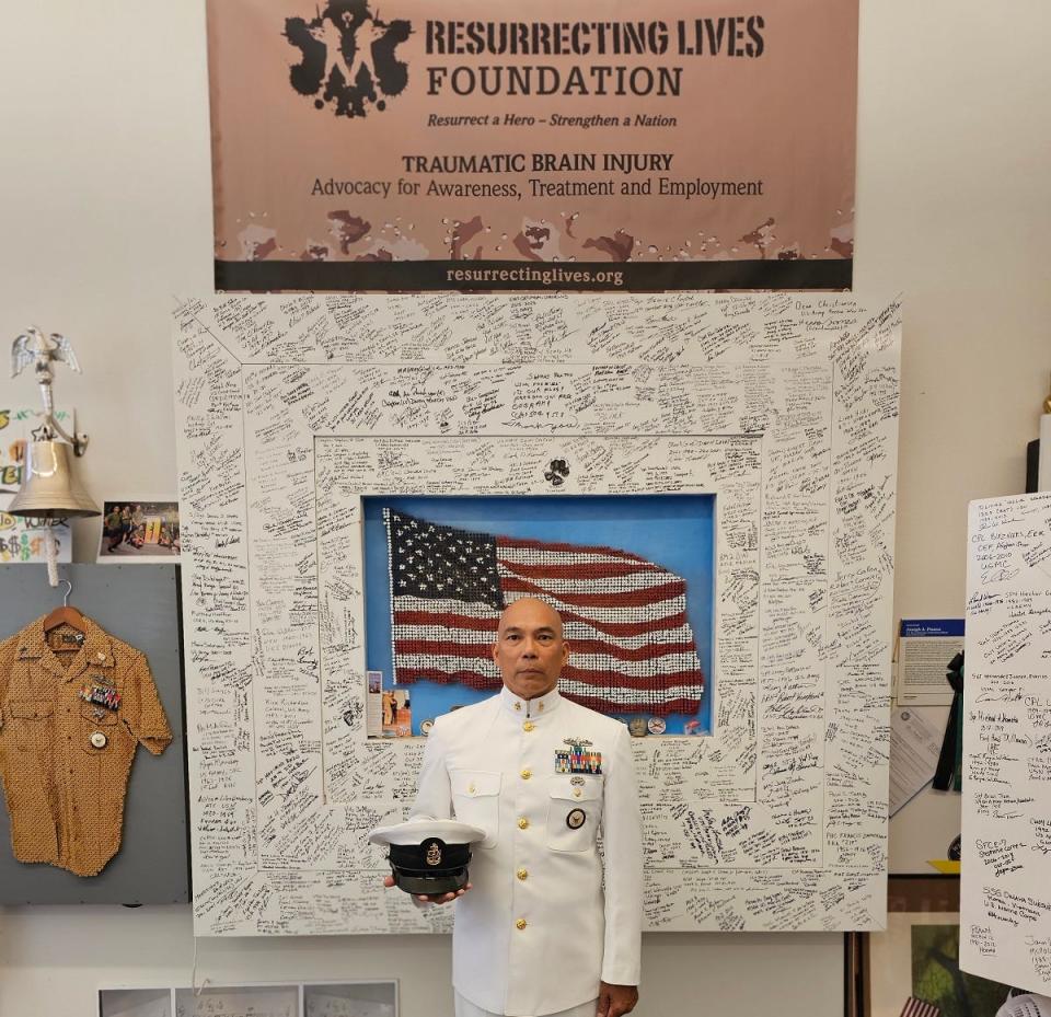 U.S. Navy Chief Petty Officer Joe Pisano with his art project, the Stand Together Flag, which will be unveiled at the National Veterans Memorial and Museum on Nov. 1.