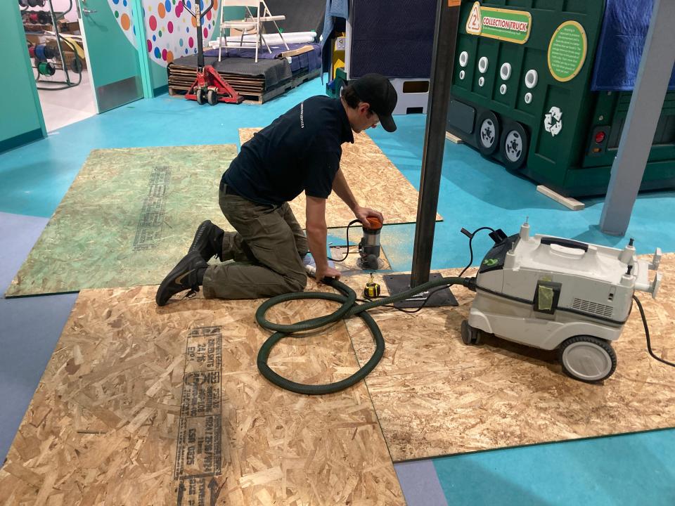 Gui Savioz prepares to install a metal beam that will support a new glass wall at the Experience Children's Museum. The new exhibit is part of a renovated building that will open to the public on July 12.