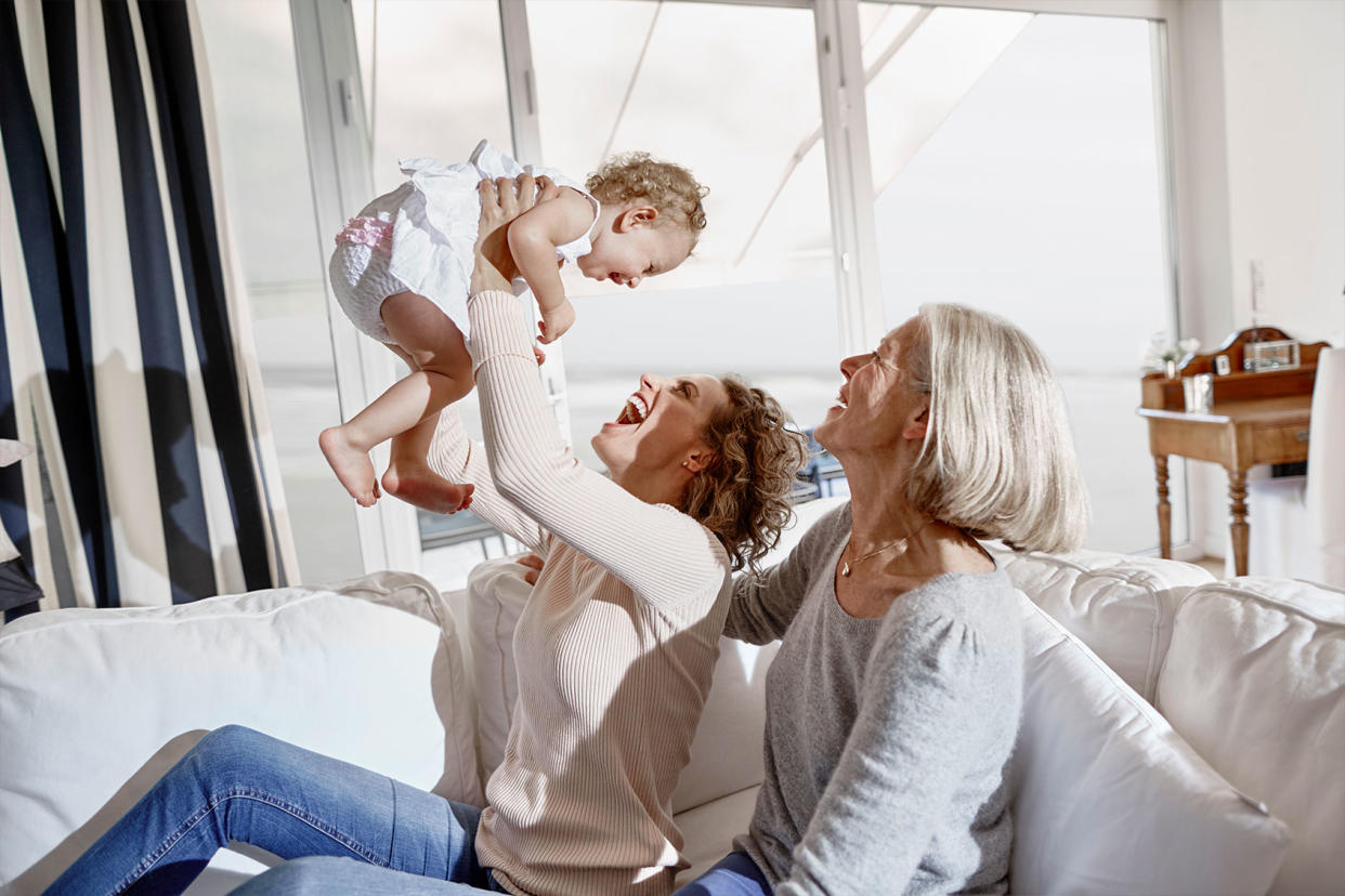 Happy mother with baby girl and grandmother at home Getty Images/Oliver Rossi