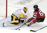 New Jersey Devils left wing Jesper Bratt (63) loses the puck as he skates in on Pittsburgh Penguins goaltender Casey DeSmith (1) during the first period of an NHL hockey game Friday, April 9, 2021, in Newark, N.J. (AP Photo/Bill Kostroun)