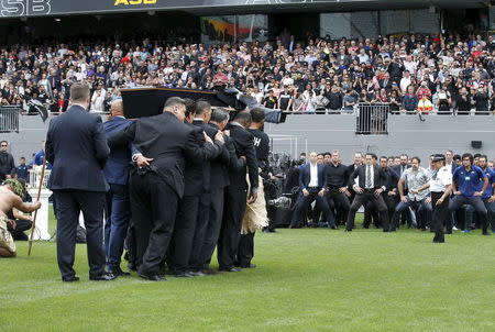 Former and present All Black's (R) watch as former All Black Jonah Lomu's casket is carried out of Eden Park during his memorial service in Auckland, New Zealand, November 30, 2015. REUTERS/Nigel Marple