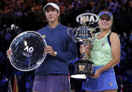 Sofia Kenin, right, of the U.S. holds the Daphne Akhurst Memorial Cup after defeating Spain's Garbine Muguruza in the women's singles final at the Australian Open tennis championship in Melbourne, Australia, Saturday, Feb. 1, 2020. (AP Photo/Lee Jin-man)