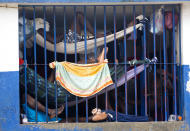 <p>Prisoners rest in makeshift hammocks inside the National Penitentiary in downtown Port-au-Prince, Haiti, Feb. 13, 2017. Prisoners in Haiti’s largest prison are crammed shoulder-to-shoulder in cellblocks so overcrowded they have to sleep in makeshift hammocks suspended from the ceiling or squeeze four to a bunk. (Photo: Dieu Nalio Chery/AP) </p>