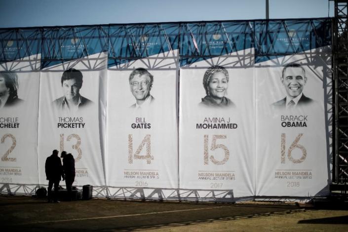 Banners depicting former US president Barack Obama, right, and other speakers who have given the Nelson Mandela Annual Lecture (AFP Photo/MARCO LONGARI)