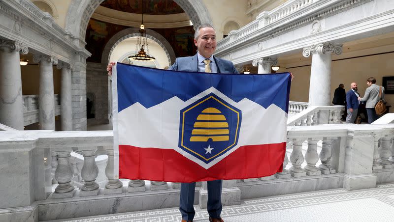 Sen. Daniel McCay, R-Riverton, sponsor of SB31, State Flag Amendments, poses for a photo with the new Utah state flag at the Capitol in Salt Lake City on Thursday, March 2, 2023.