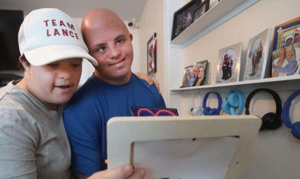 Lance Avery and friend Rilea Jackson look at some of Lance's photographs, Tuesday, Sept. 27, 2022, at his Ormond Beach home.