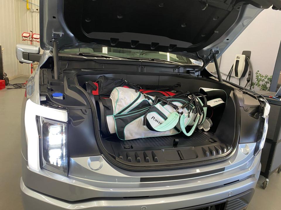 The 2022 Ford F-150 Lightning electric pickup's 400L front storage compartment has room for two standard golf bags, plus drainable under floor storage.